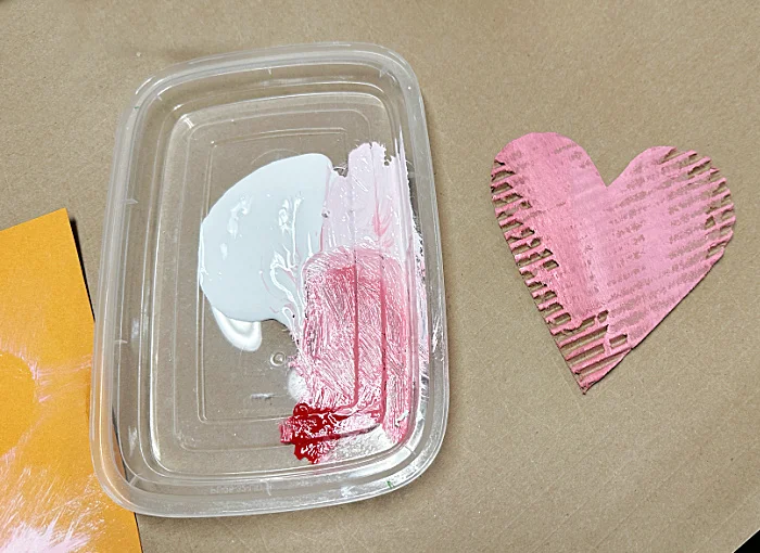 pink paint and cardboard heart