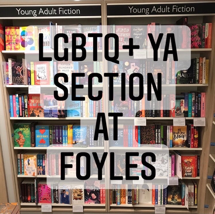 A photo of thd LGBTQ+ YA section at Foyles, Charing Cross Road, face on. It consists of two bays/bookcases. Over it are the words LGBTQ+ YA Section at Foyles in black, with a transparent white background.