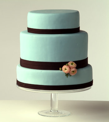 Three tier square wedding cake in light blue with brown swirls