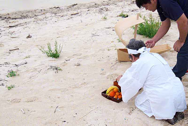 priestess, fruit tray,assistant, sand, beach