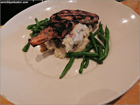 Grilled Pork Chop: Center-Cut Chop Served with Housemade Apple Sauce, Mashed Potatoes and Fresh Spinach