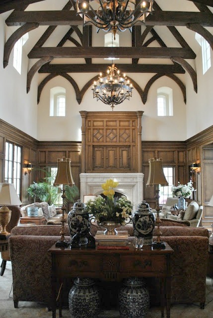 Breathtaking architecture in Enchanted Home family room with wood beams and paneling