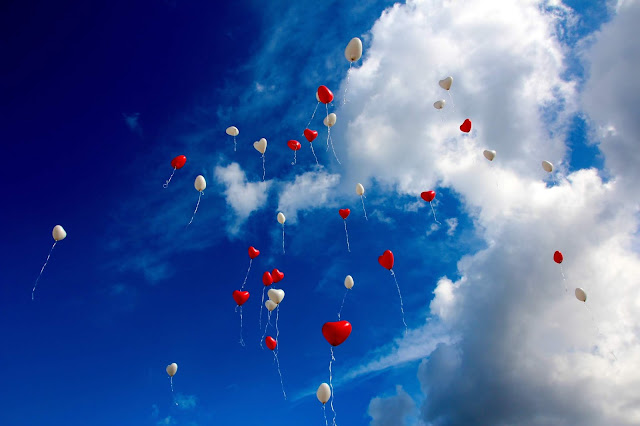 Balloons are flying high in the blue sky