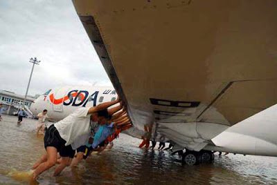 Airplane being push out of flooded areas