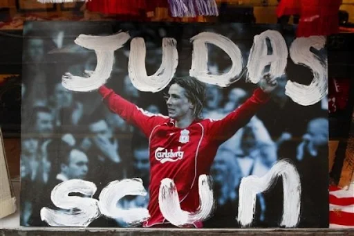 A defaced Fernando Torres photograph is displayed in the window of a souvenir shop in Liverpool