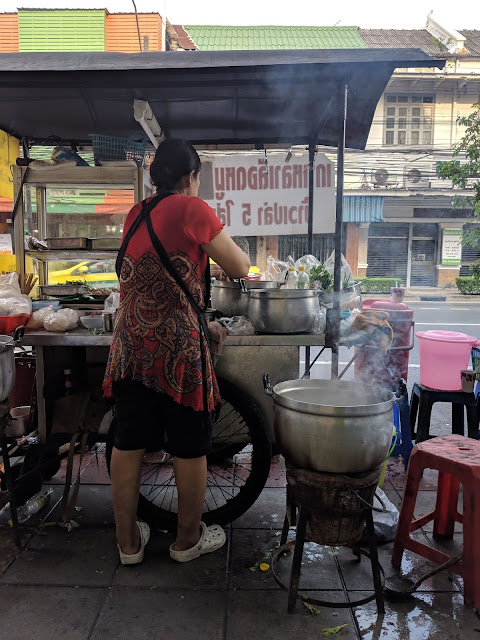 Cooking up congee on the street in Bangkok, Thailand