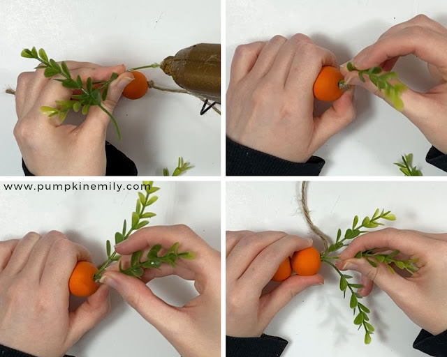 Gluing green plants on the largest bead of a wood bead carrot.