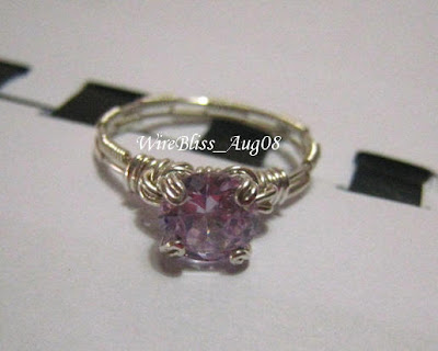 wire wrapped prong ring in sterling silver wire and a light purple crystal