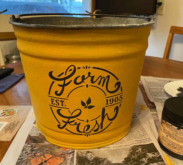 Photo of a painted and stenciled galvanized planter bucket.