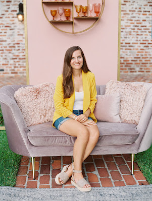 Jaclyn Fraser wedding planner smiling on couch