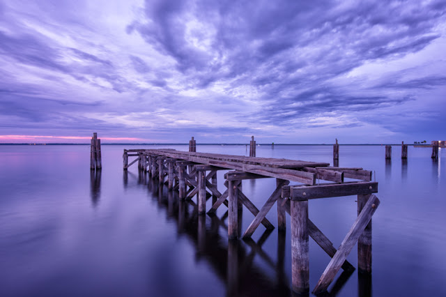 cloudy evening at old pier at lake monroe