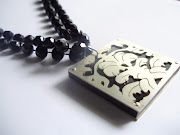 Silver neckpiece with flocked wallpaper pattern over black acrylic (pb )