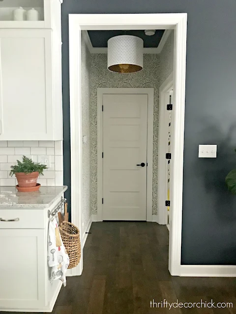 Decorating a small hallway with wallpaper and paint