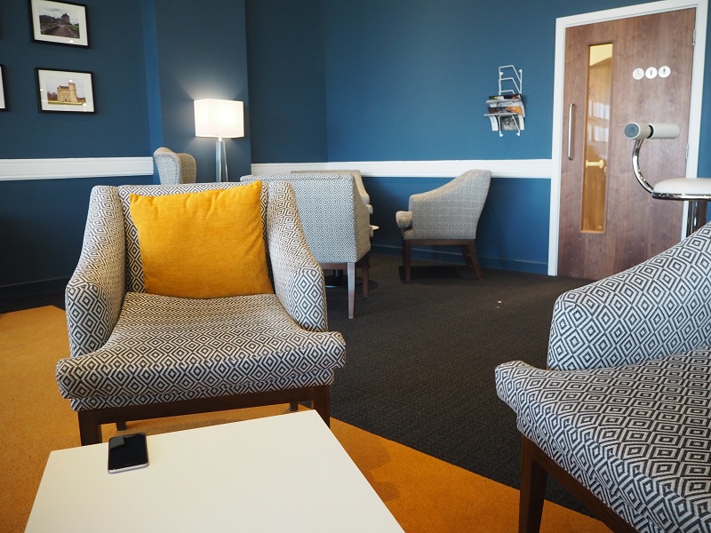 Monochrome seats with yellow cushions in Aberdeen Airport's lounge