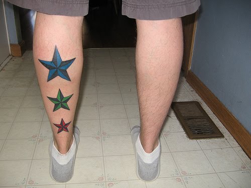 this colourful trio of Nautical Star Tattoos running up this guys leg