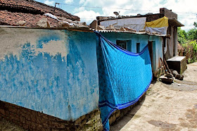 sari drying on a village wall