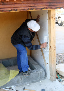 Bekir skims the insulation