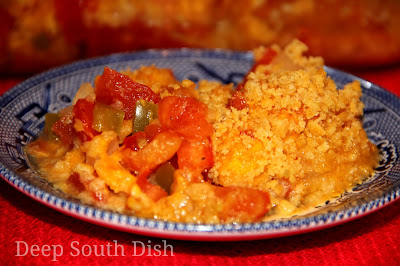 Fresh garden tomatoes, seasoned with salt, pepper, Cajun seasoning, fresh basil and brown sugar, in a casserole made with the trinity of Deep South veggies - onion, bell pepper and celery - and topped with shredded cheddar cheese and buttery cracker crumbs.
