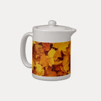 tea pot with fall leaves pictured on it