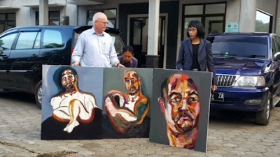 Lawyer Julian McMahon with three self-portraits by Myuran Sukumaran
