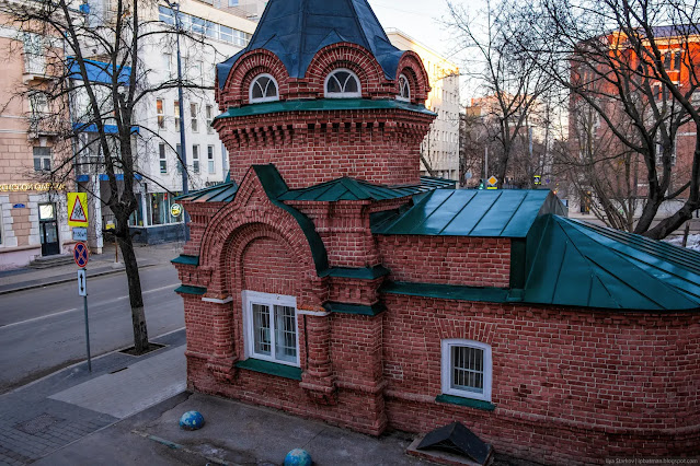 Старая кирпичная часовня вреди городской застройки