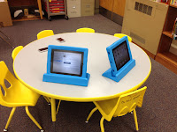 picture of two ipads and two ipods on a table