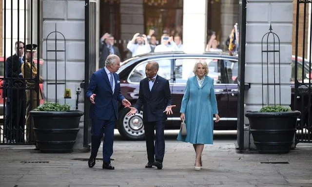 Queen Camilla wore a sky blue midi dress. Charlotte Elizabeth taupe handbag and Eliot Zed pumps. Pearl earrings