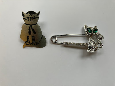 two cat brooches