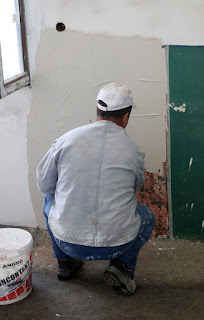 Plastering over the patched up walls