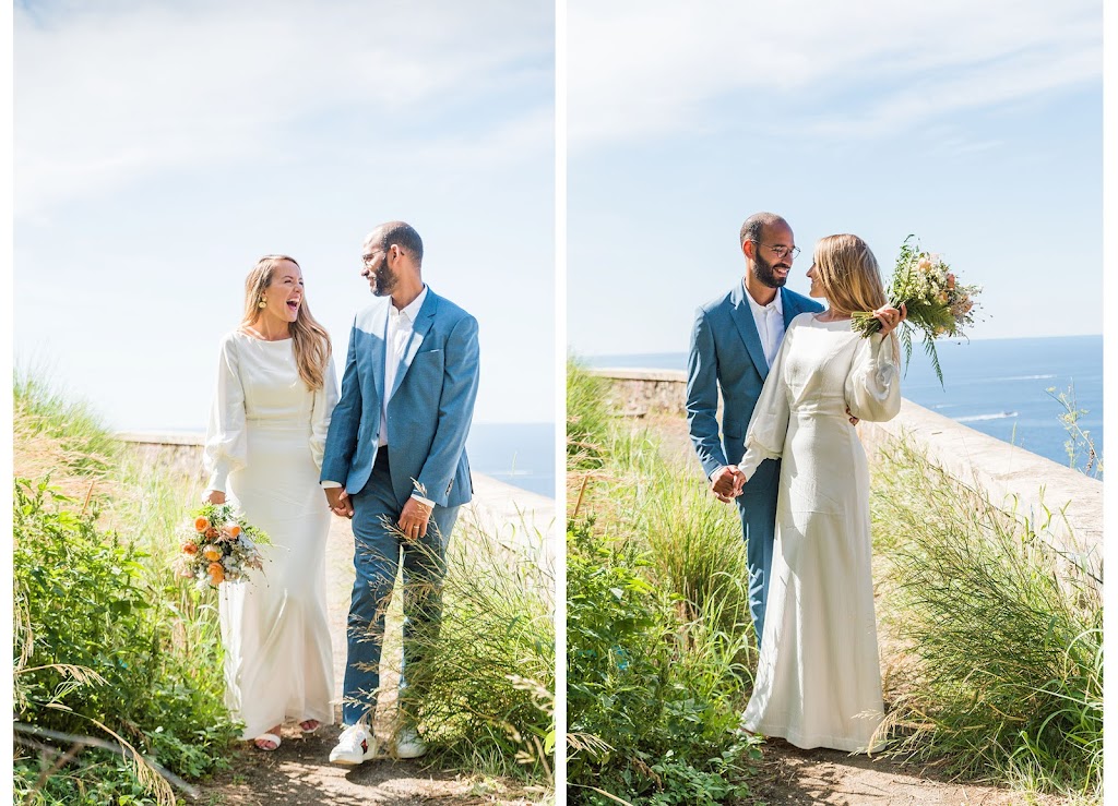 Bride and groom laughing in long grass