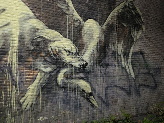 "Alas! how pitiful." street art  Mural By Faith47 In Heerlen, Netherlands. dog and swan