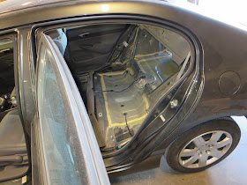 Interior of car with seats and interior panels removed so new floor can be installed.