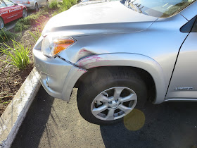 Dented fender and scraped bumper on 2012 Rav4 before collision repairs at Almost Everything Auto Body