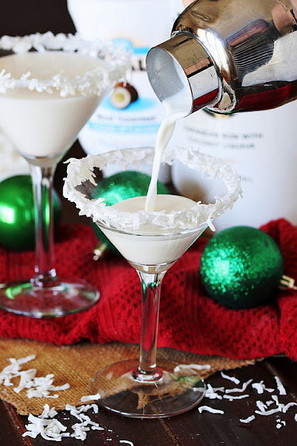 Pouring a Coconut Snowball Cocktail into a Martini Glass Image