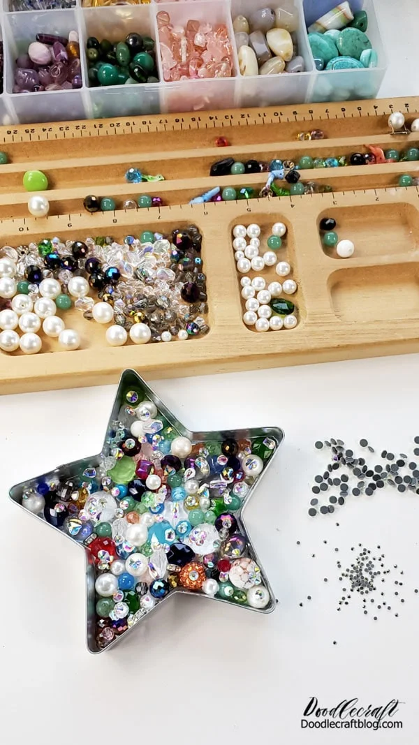 Step 3: Add Rhinestones!  Now that the beads are in the base and are dry, begin gluing rhinestones in every little space possible.   Use this opportunity to cover any bead holes with little sparkly rhinestones.