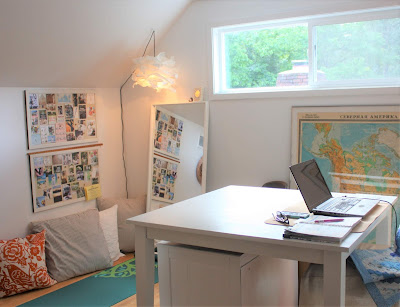 a white room with a table and a yoga mat