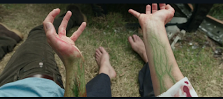 Jen holding up her hands, her skin and veins turning a venomous green as she transforms for the first time.