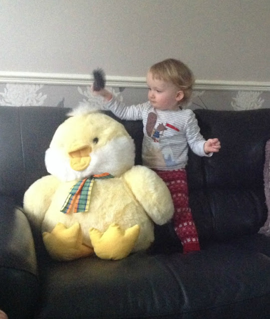 toddler brushing soft toys hair