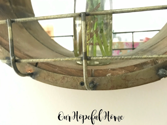 round wooden farmhouse mirror wire cage vintage milk bottle vase fresh cut flowers