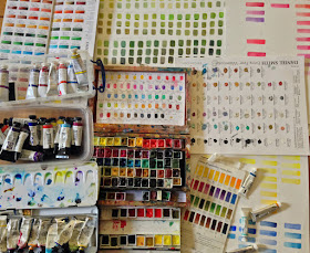 Photograph of watercolour paints and colour charts