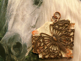 Flat stone wrapped in Vintaj filigree butterfly :: All Pretty Things