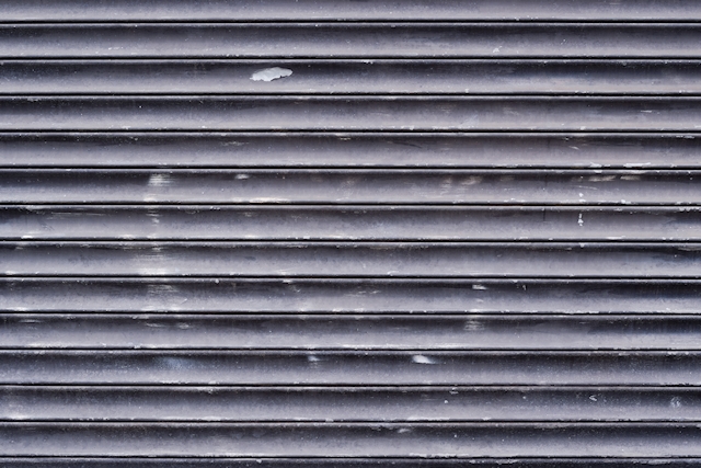 Black painted metal pull down shutter texture