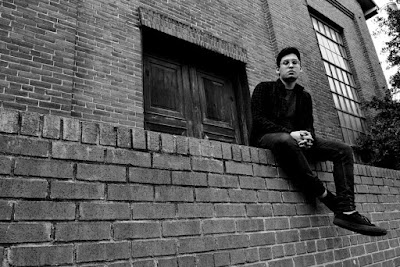 The man sit on wall lonely looking for something