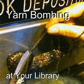 Close-up view of hands cutting thread on piece of crochet that has been stitched around the handle of a library book-drop. The words 'Yarn Bombing at Your Library' have been superimposed on the image.