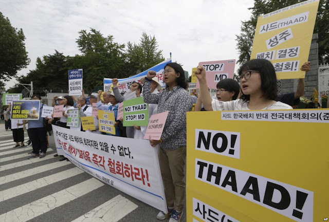 People protest against the deployment of the Terminal High Altitude Area Defense (THAAD)