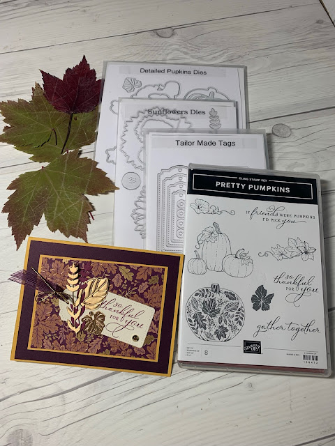 Press Fall leaves next to craft items used to create this fall-themed greeting card