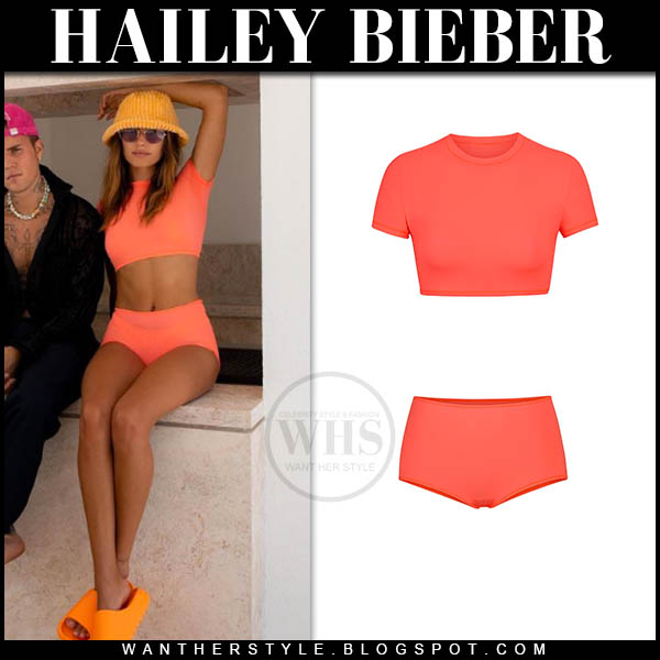 Hailey Bieber in neon orange crop top and orange shorts