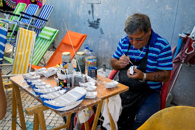 A man crafting small boats