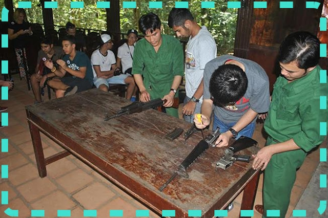 Tourists in a class of teaching how to disassemble and reassemble a gun in the Cu Chi Tunnels Vietnam – Photo credit: Ginkgo Voyage Travel Agency