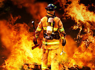 A brave firefighter fighting a fierce fire.